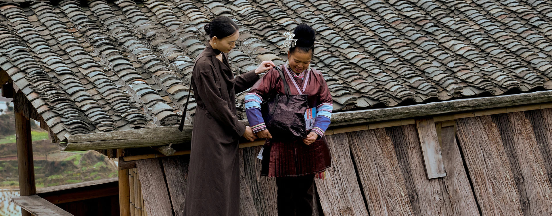 A young woman putting the Bampo Dong Cloth Tote on a Dong tribe woman