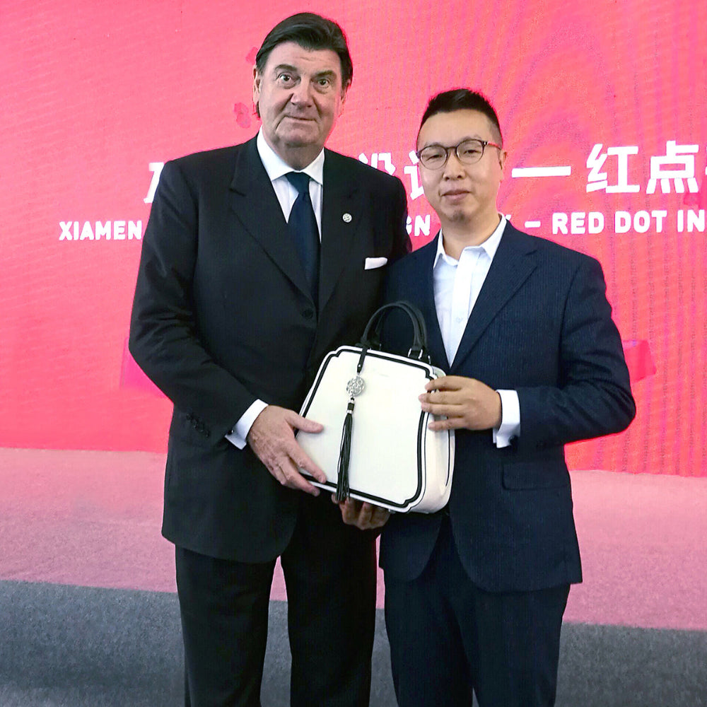 Bampo founder Huang Lang accepting the China Good Design Award from the German Red Dot in 2017 for exceptional craftsmanship