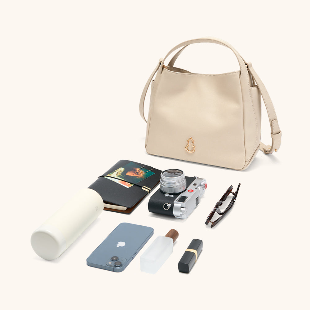 Items laid out to show Bampo Drum Tote capacity