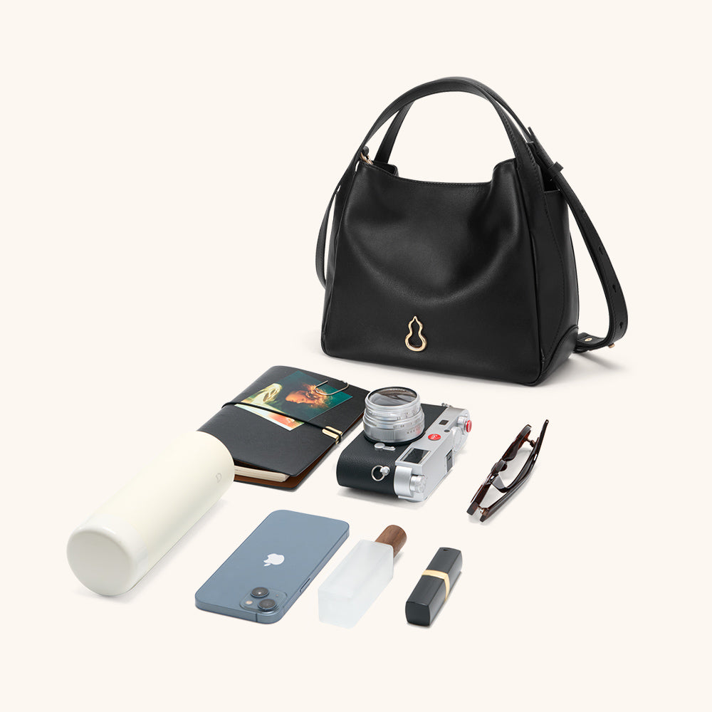 Items laid out to show Bampo Drum Tote capacity