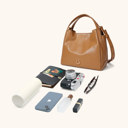 Items laid out to show Bampo Drum Tote capacity