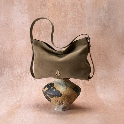 Side View of the Bampo Medium Flow Hobo double faced suede