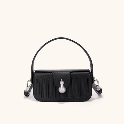 Black leather handbag with hulu-shape hardware | Bampo
