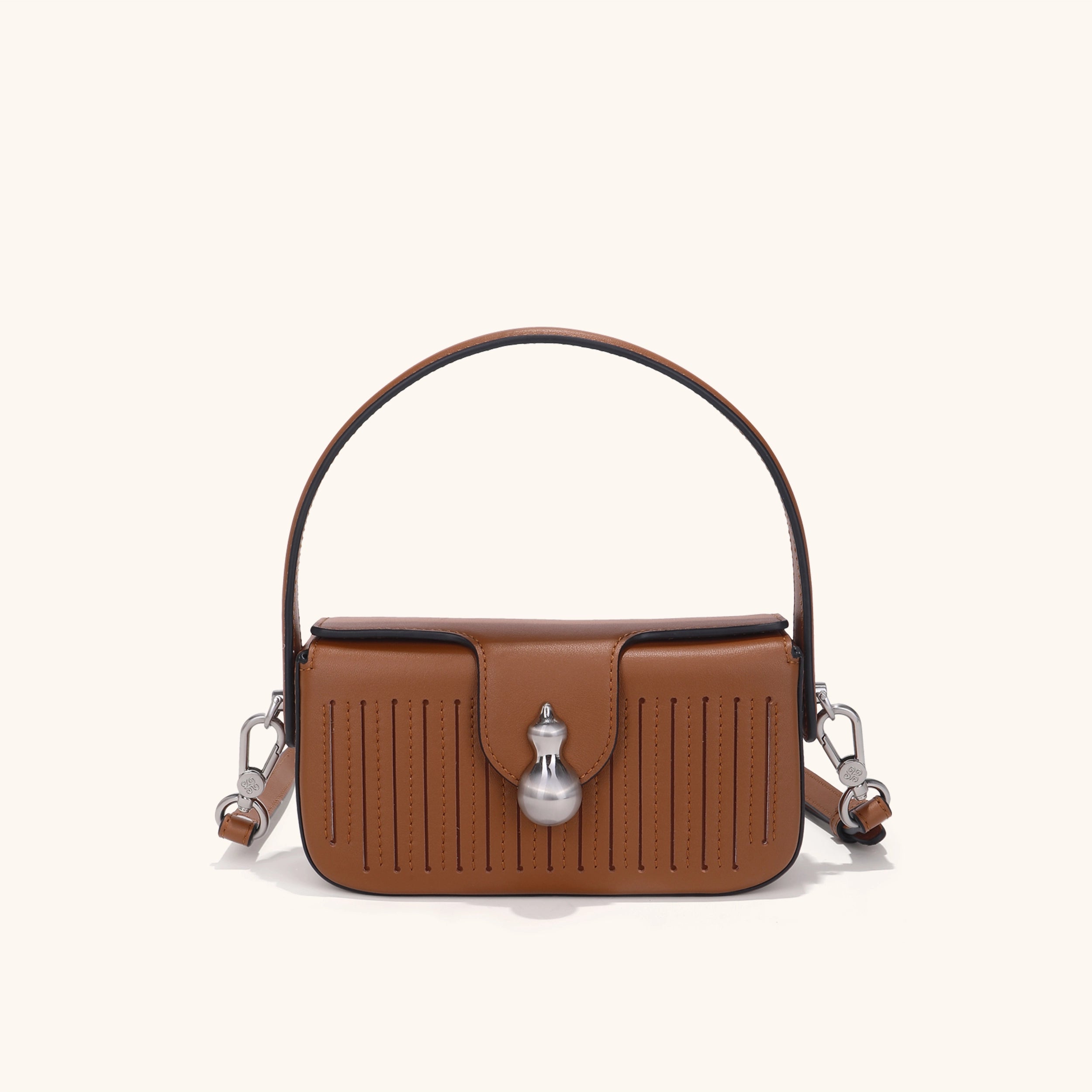 Brown leather handbag with hulu-shaped hardware | Bampo